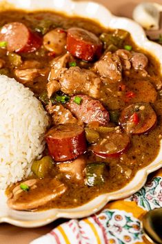 a plate with rice, meat and vegetables on it