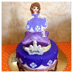 there is a purple cake with a princess on it