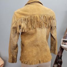 vtg 1940s tan beige fringe buckskin jacket fits like a womens  small  no tags toggle buttons up the front 2 pockets Material: leather/suede/ buckskin Some heavy wear, no lining. soft and worn in Measurements Lying Flat: Shoulders: 17" Bust: 17.5" Waist: 18" Length: 23" Sleeve length: 22" sleeve opening: 8" Buckskin Jacket, Buckskin Clothing, Davy Crockett, Toggle Button, Jacket Fits, Easy Rider, Fringe Jacket, Jacket Vintage, Tan Leather