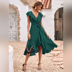 New Chic Ruffle Wrap Tie Midi Dress * Wrap Deep V Neckline * Ruffle Trim * High Waist * Belted Tie Waist * A Line Flare High Low Skirt * Ruffle Hem * Short Flutter Sleeve * Side Zip *Approximate Unstretched Measurements* Small (4) * Bust 35.25" * Waist 28.5" * Length 47" Medium (6) * Bust 37" * Waist 30" * Length 47.5" Large (8/10)* Bust 39.25" * Waist 32.5" * Length 48.25" Xl (12) * Bust 41.5" * Waist 35" * Length 49" On Order* Will Ship In 5-10 Days Fabric : Soft Flowy Poly Color : Dark Green Elegant Green V-neck Ruffle Dress, Chic Green Dress With Ruffle Hem, Elegant Ruffle Dress For Vacation, Elegant Ruffle Dress With Ruffled Skirt For Vacation, Elegant Midi Dress With Ruffle Hem For Vacation, Elegant Dress With Ruffled Skirt For Day Out, Chic Green Dress With Ruffles, Green Chiffon Dresses With Ruffle Hem, Elegant Beach Midi Dress With Ruffled Skirt