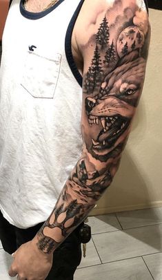 a man with a wolf and trees tattoo on his arm is standing in front of a wall