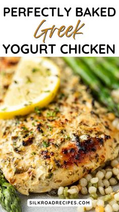 a plate with chicken, asparagus and lemon on it that says perfectly baked greek yogurt chicken