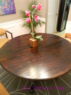 a wooden table with flowers in a vase on top