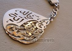 Key chain name arabic and phrase made to order customized sterling silver 925 big size في حفظ الرحمن - 2 اسماء عربي The names on the sample Khaled and Aya The phrase In god protection . خالد و آية في حفظ الرحمن please allow 10 to 15 days to complete , this is made to order item . write your name or the name you want in English or Arabic , with the order please . A sketch drawing of the names will be sent to you after 2 -3 days of payment for confirmation before we work on silver - see pictures- Traditional Silver Customized Jewelry, Traditional Customized Silver Jewelry, Customized Traditional Silver Jewelry, Custom Silver Nameplate Jewelry, Silver Personalized Name Jewelry, Custom Silver Jewelry With Name, Arabic Name Necklace, Arab Name Necklace, Arabic Keychain