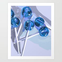 several blue candy lollipops sitting on top of each other