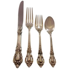 four forks and two spoons with ornate designs