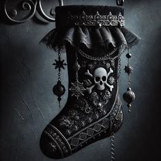 a black christmas stocking with skulls hanging from it's side and decorations on the bottom