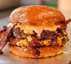 a cheeseburger with bacon and melted cheese