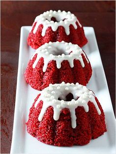 two red velvet cakes with white icing on a plate, ready to be eaten