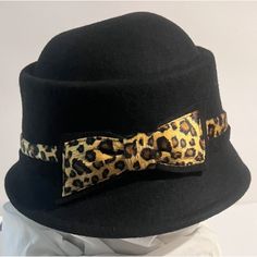 Adora 100% Wool Cloche Hat Womens One Size Black Leopard Print Bow Band New. Gorgeous Hard To Find Hat By Adora. Beautiful Leopard Bow And Banding. One Size. 100% Wool New With Tags Has A Fold In The Underside Of The Brim From Storage, See Last Photo. Can Likely Be Ironed Out If Desired But I Don’t Find It To Be Noticeable When Worn. Adjustable Brimmed Black Cloche Hat, Black Brimmed Mini Hat For Fall, Adjustable Black Brimmed Cloche Hat, Black Mini Hat With Short Brim For Fall, Adjustable Black Cloche Hat For Parties, Black Adjustable Cloche Hat For Party, Black Cloche Hat For Party, Classic Black Mini Hat For Winter, Black Wool Hat With Short Brim