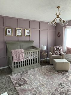 a baby's room with purple walls and furniture