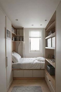 a small bedroom with a bed and shelves