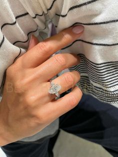 a woman's hand with a diamond ring on it