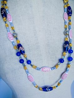 Artisan Blue Double Strand Beaded Necklace, Luxury Blue Double Strand Beaded Necklace, Blue Double Strand Faceted Bead Jewelry, Blue Double Strand Necklace With Faceted Beads, Blue Multi-strand Wooden Bead Necklaces, Necklace African, Double Strand Necklace, Cedar Rapids, Blue Feather