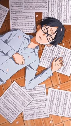 a man laying on the floor surrounded by sheets of music paper with sheet music notes all around him