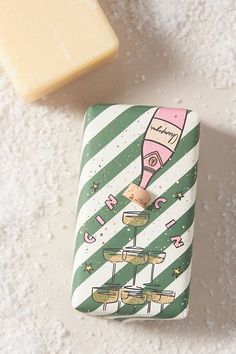 a soap bar next to a green and white striped lighter holder