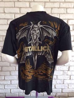 This is a great Metallica shirt from the early 90's The design is awesome, printed back and frontThere are a bunch of holes all over the shirt so please take a look at the picturesSize XL on tagPit to pit : 25,2 inchesTotal length: 28,35 inchesAs for all of my tee shirts, there's only one so take it or miss it :)Other model of Metallica shirt here : https://www.etsy.com/listing/547277108/metallica-1993-vintage-metallifukinca-t?ref=shop_home_active_3To enjoy exclusive updates on all our products, Metallica Costume, Vintage Cotton T-shirt With All Over Print, Grunge Graphic Print Shirt For Fans, Grunge Graffiti Print T-shirt For Fans, Grunge Graffiti Print Fan T-shirt, Grunge Graffiti Print T-shirt, Alternative Graphic Print Festival Tops, Alternative Graffiti Print T-shirt For Fans, Alternative Graffiti Print T-shirt For Fan Merchandise