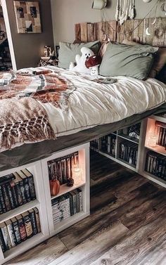 a bed with bookshelves underneath it and a stuffed animal on the bottom shelf