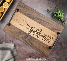 a wooden cutting board with the words goslingin on it next to sliced oranges