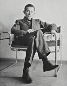 a man sitting in a chair with his legs crossed