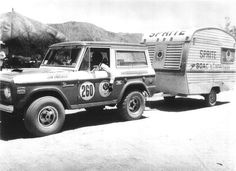 an old black and white photo of a truck with a trailer attached to the back