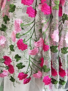 pink and green flowers on white sheer fabric