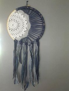 a blue and white dream catcher hanging on the wall