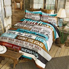 a bed with a cowboy themed comforter and pillows on top of wooden flooring