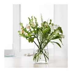 a vase filled with white flowers on top of a table