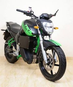 a green and black motorcycle parked in a room