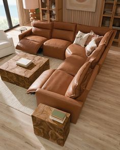 a living room filled with lots of brown furniture