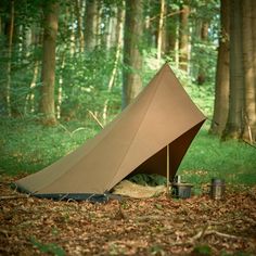 a tent pitched up in the middle of a forest