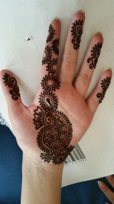 a person's hand with henna tattoos on it