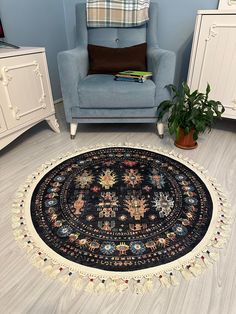 a blue chair sitting next to a black and white rug