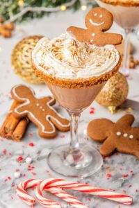 two glasses filled with dessert and gingerbread cookies