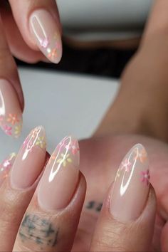 a woman's nails with flowers on them