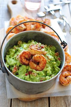 shrimp and guacamole in a pot on a wooden table