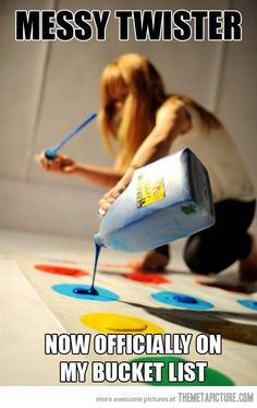 a woman is painting on the floor with paint