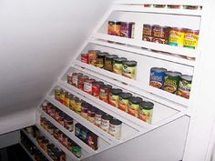 an open refrigerator filled with lots of canned food and condiments on the shelves