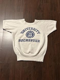 Vintage 1950s University of Rochester Champion Running Man Collegiate Varsity Short Sleeve Crewneck Sweatshirt Pullover Made in USA Size fits S Measures 20x22.5 inches Retro Short Sleeve Cotton Sweatshirt, Retro Cotton Short Sleeve Sweatshirt, Vintage Cotton Sweatshirt, Vintage Cotton Tops For College, Vintage Crew Neck Tops For College, Vintage College Tops With Letter Print, Vintage Letter Print Tops For College, Vintage Short Sleeve Cotton Sweatshirt, 1950s Style Short Sleeve Cotton Top