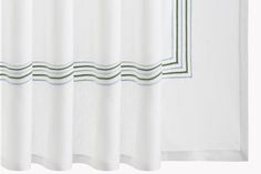 a white curtain with green trim on it