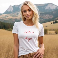 White Santa's Angel Tee Classic t-shirt with a slim feminine fit, crew neck and short sleeves. Made from superior combed and ring-spun cotton. . .: 100% airlume combed and ringspun cotton (fiber content may vary for different colors) .: Light fabric (4.2 oz/yd² (142 g/m .: Slim fit with longer body length .: Tear away label .: Runs smaller than usual Fitted Short Sleeve Tops Gift, Fitted Short Sleeve Tops For Gift, Fitted Short Sleeve Christmas Top, Fitted Crew Neck T-shirt As A Gift, Fitted White T-shirt As Gift, Christmas Gift For Her, T Shirt For Women, Shirt For Women, Christmas Gifts For Her