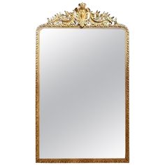 an ornate gold framed mirror against a white background