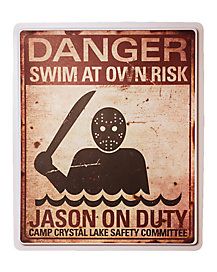 a sign that says danger swim at own risk, with an image of a person holding a knife in the water