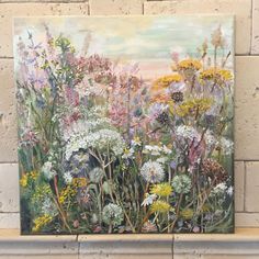 an oil painting of wildflowers on a brick wall