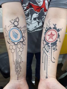 two people with tattoos on their arms