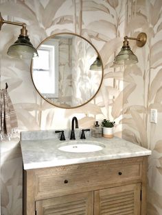 a bathroom with a sink, mirror and light fixture in the corner on the wall