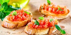 three pieces of bread topped with tomatoes and basil