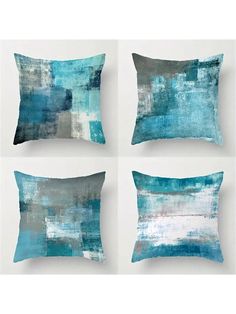 four pillows with blue and white paint on them