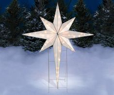 a lighted christmas star in the snow